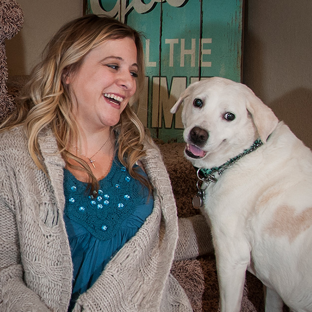 girl smiling at dog