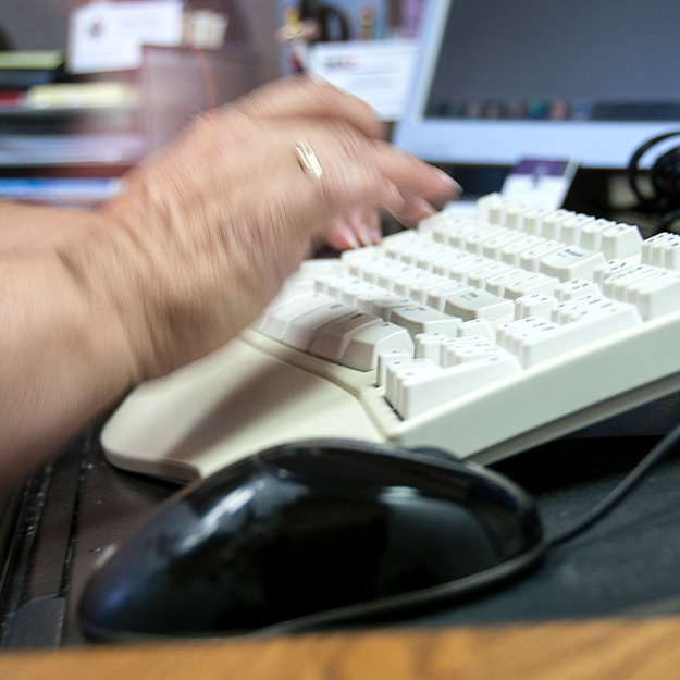 hands typing on a keyboard