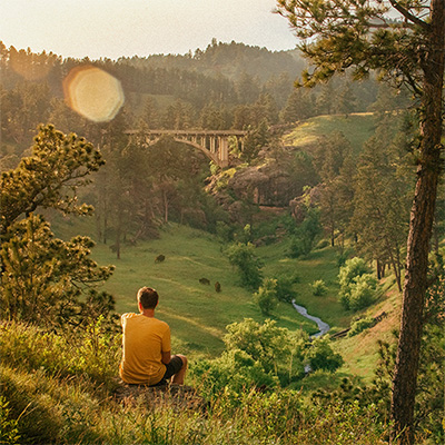 man looking out over a canyon 