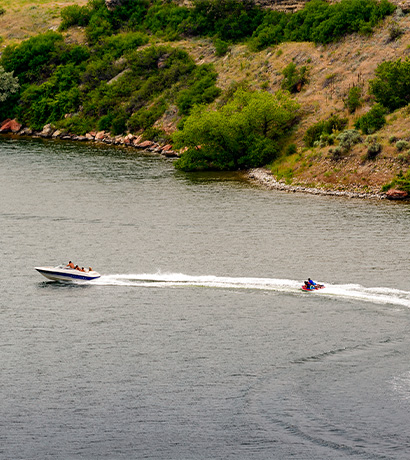 boat pulling a tube on the river